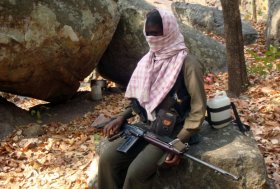 In this picture taken on March 24, 2012 a Maoist sits near the unseen abducted Italian tourist Claudio Colangelo and tour operator Paolo Bosusco in the Gajalbadi reserve forest in Kandamal district of Orissa state, India. Commander Sabyasachi Panda handed over Italian tourist Claudio Colangelo March 25 to the crew of a TV news channel, who trekked to the place where Colangelo and Italian tour operator Paolo Bosusco were being held. The two were abducted on March 14 while on a trek through a densely forested area of Orissa state. AFP PHOTO/STR (Photo credit should read STRDEL/AFP/Getty Images)